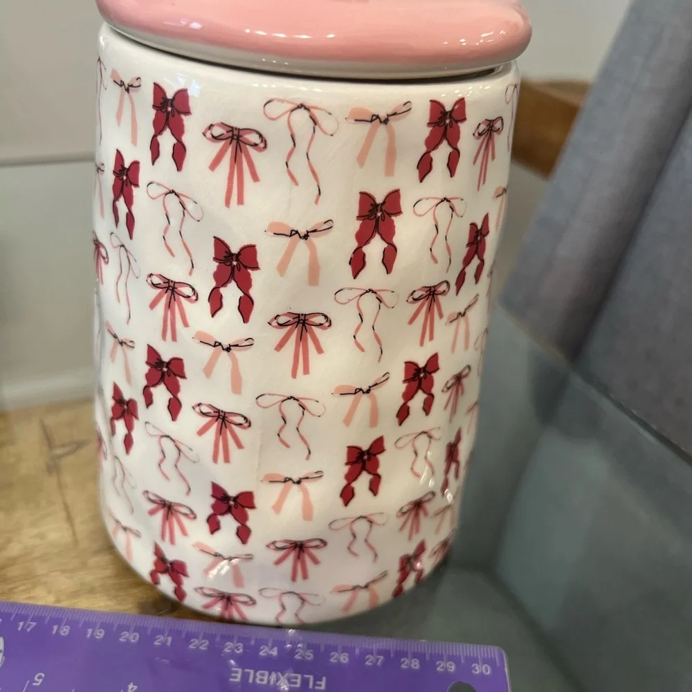 canister jar with a pink bow design, from the brand 10 Strawberry Stree
